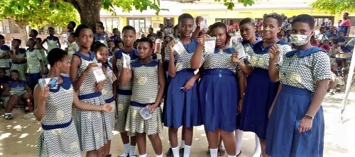 Some beneficiary schoolgirls displaying the menstrual cups after they were educated on how to use them